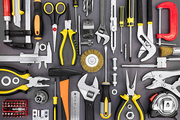 set of hand various work tools on grey background top view including different kinds of wrenches, pliers, clamps, calipers and other