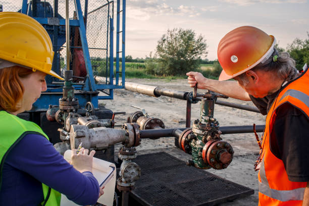 Engineers at oil field check pressure valve